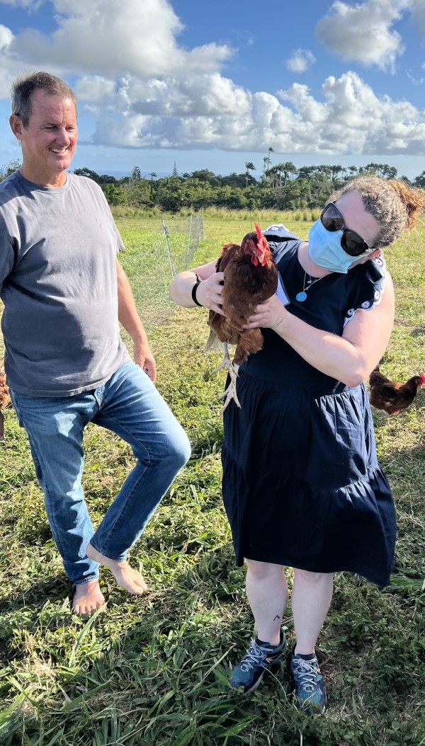 Graduate student Molly Connors holds a chicken at PEG Farm in Barbados.