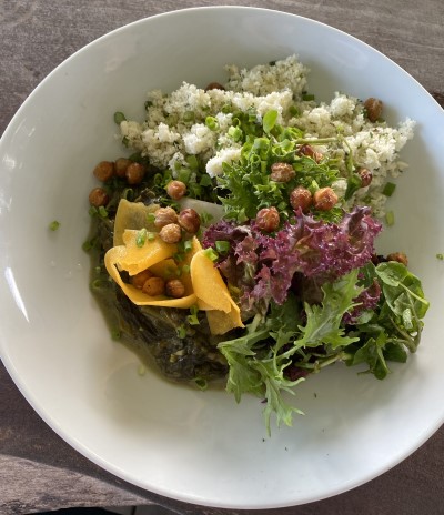 White serving bowl with quinoa, chickpea and salad greens — one of the vegetarian offerings served at the cafe at PEG Farm and Nature Reserve in Barbados.