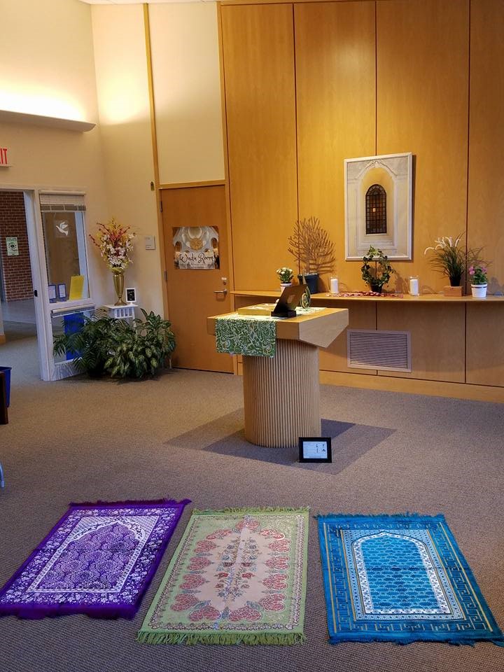 Three prayer rugs are arranged in the Sacred Space.
