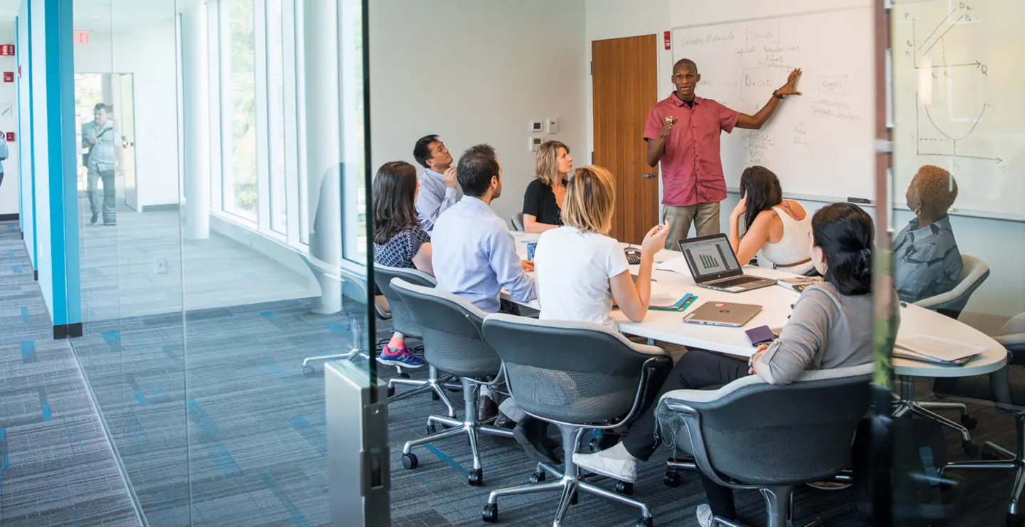 group of graduute students works together at a table