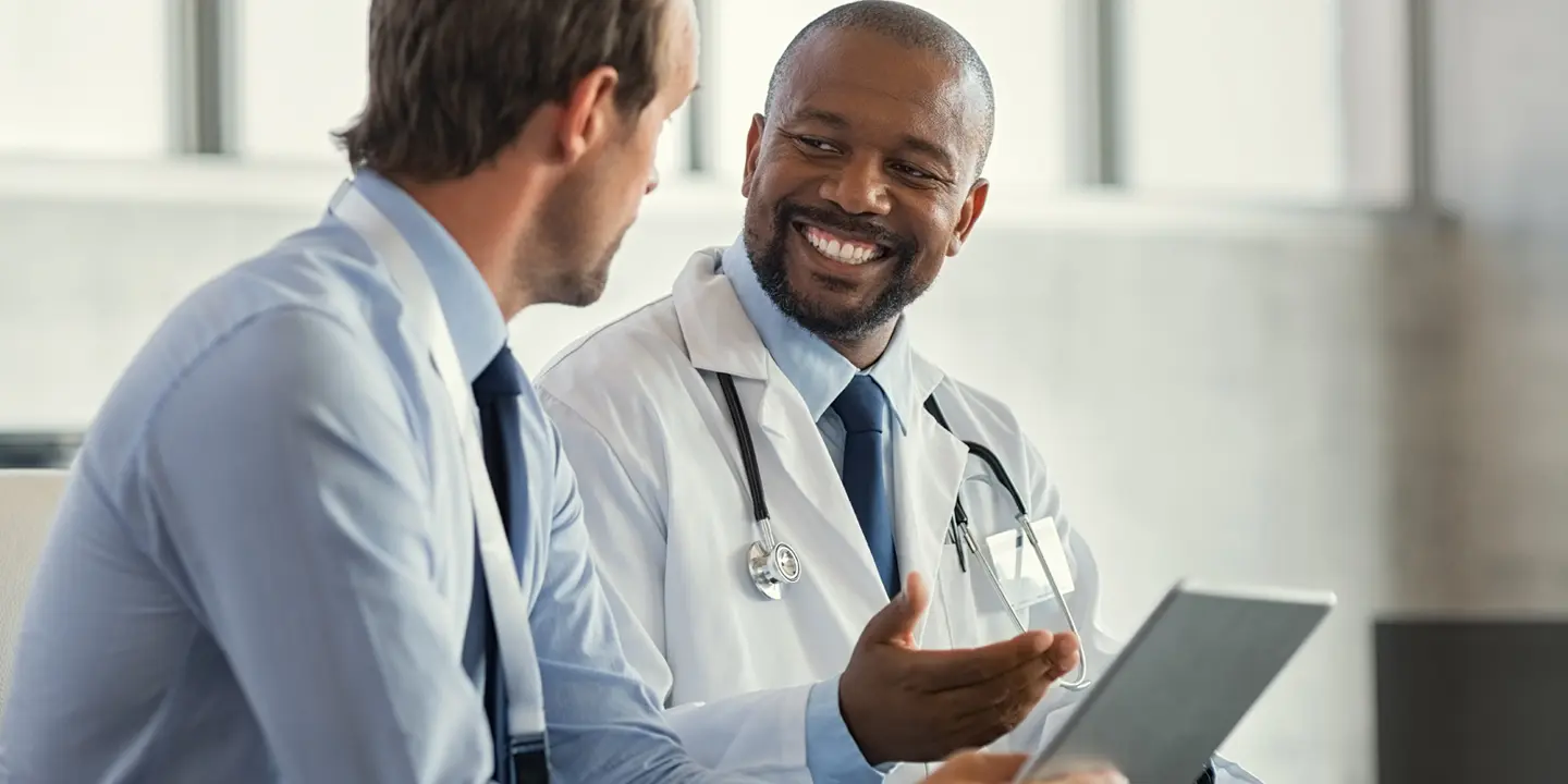 two doctors talking and smiling