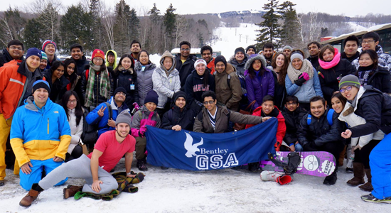 Students sitting with a banner - graduate student association