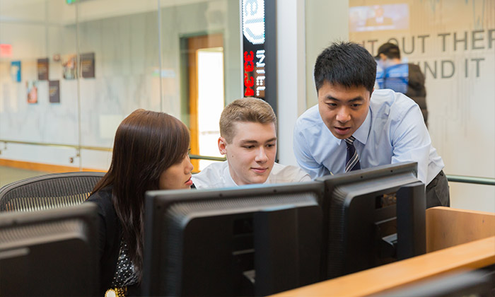 3 People looking at a computer screen together