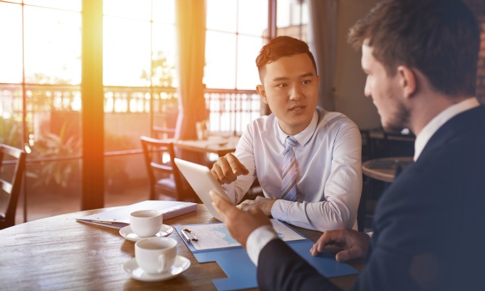 Two men talking at a table