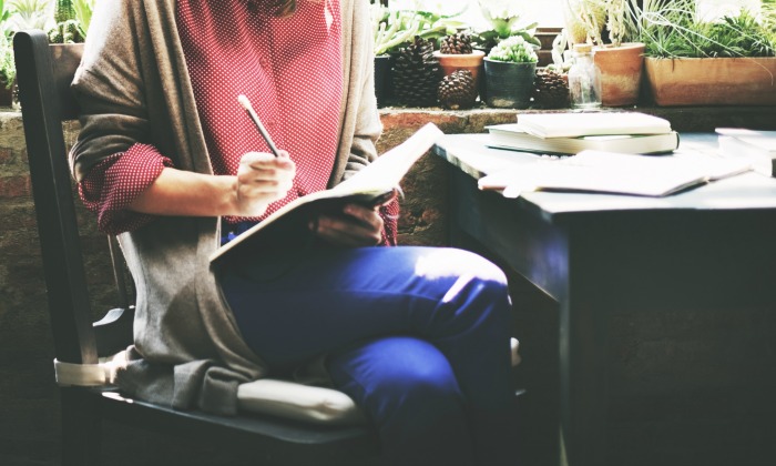 Woman writing in notebook