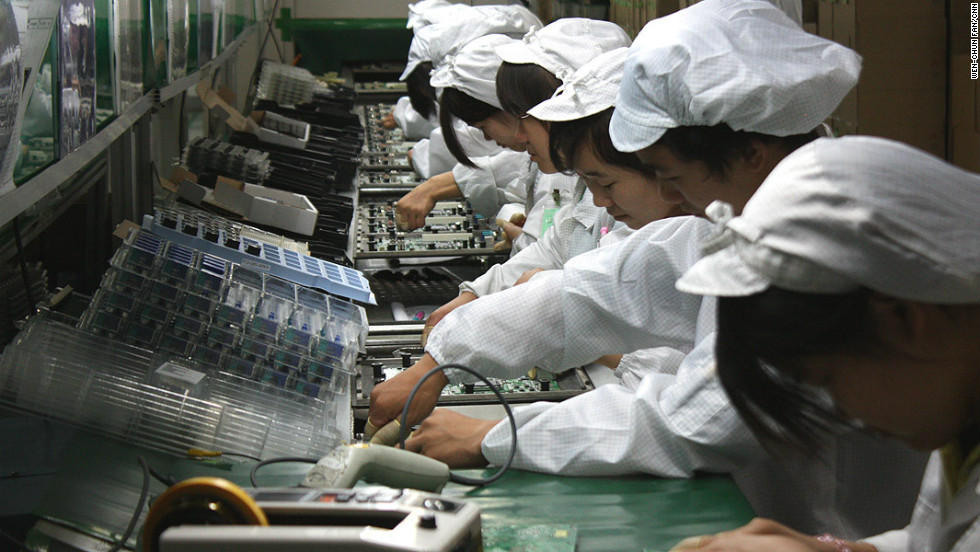 Factory workers working on computer parts