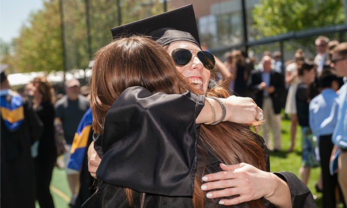 Graduates hugging 