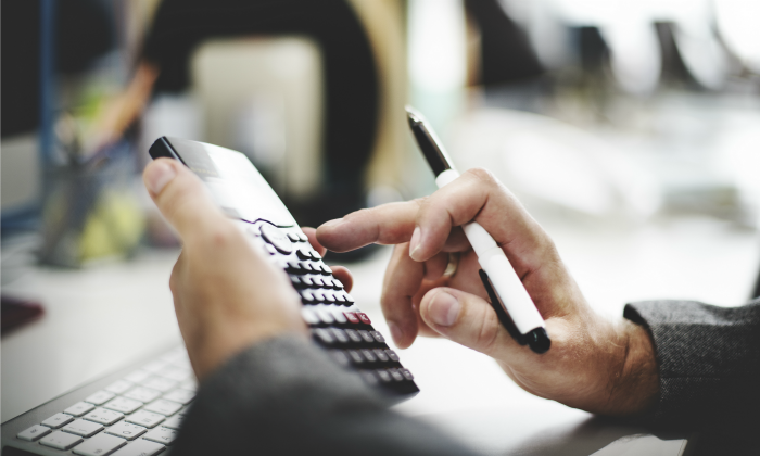 Man using calculator 