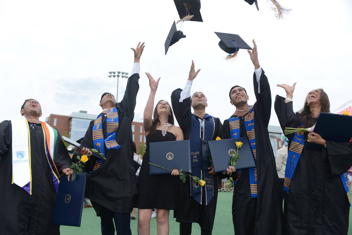 Graduates throwing their caps into the air