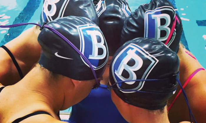 Bentley Swim Team huddled together 