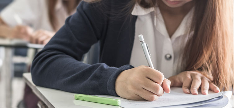 Woman writing with pen and paper