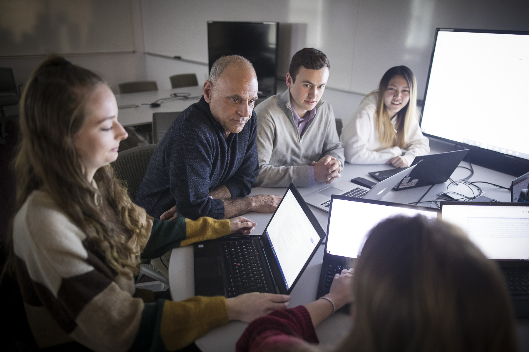 professor and students work in a small group