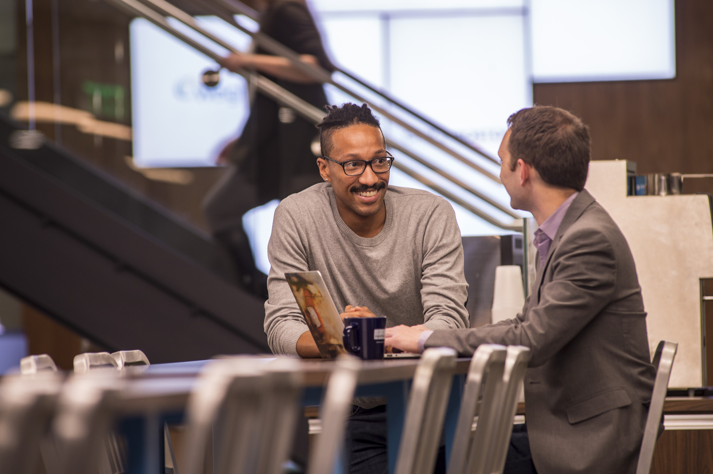 Two employees sitting at a conference table