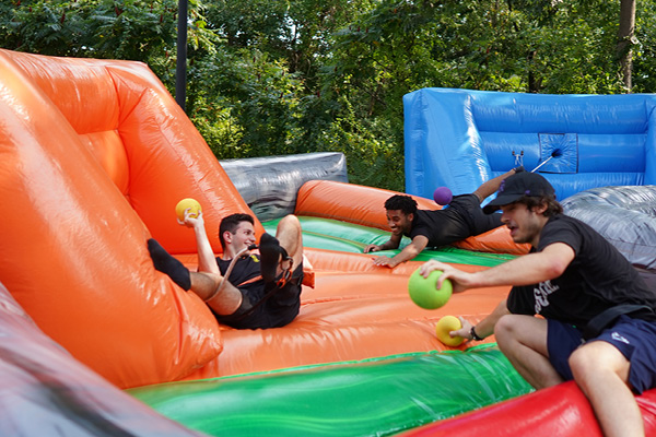 Students play a game on inflatables