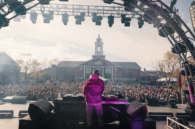 DJ Diplo performing on stage in front of large crowd