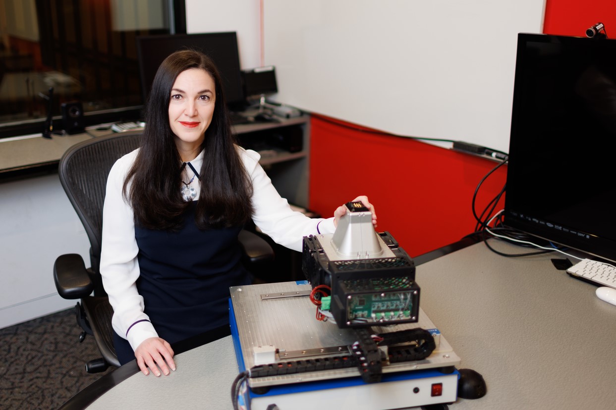 Professor Mounia Ziat sits at table, upon which is the machine she will use to test edge perception. 