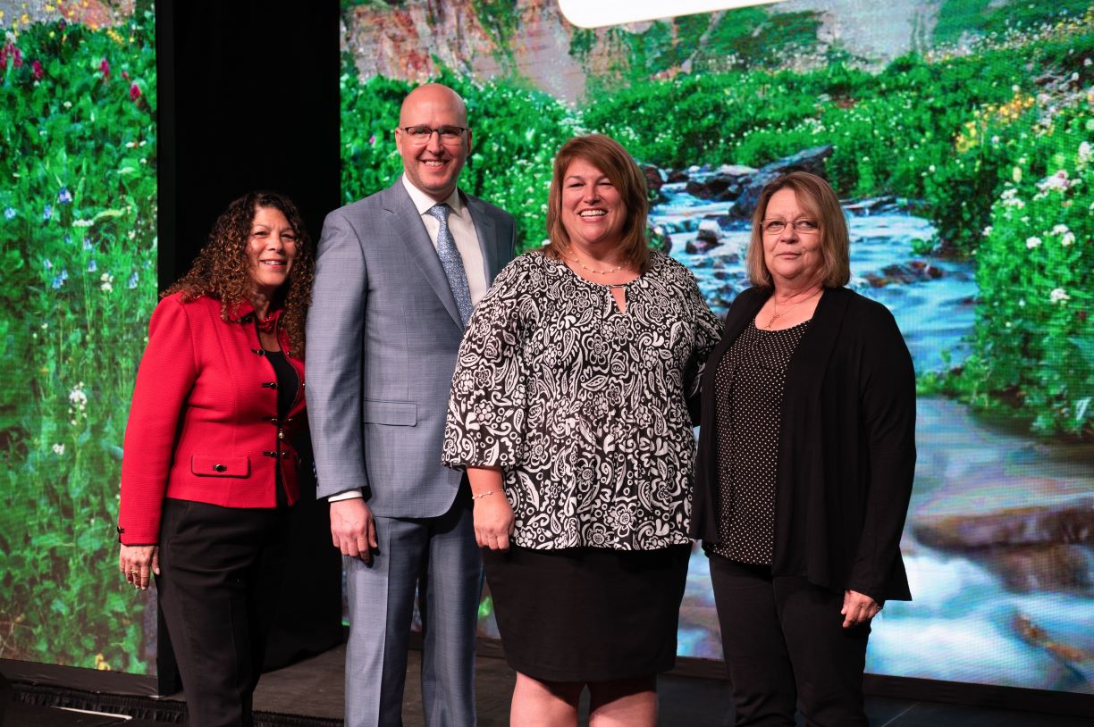 Bentley professors Dave Szymanski and Tracy Noga, center, with Ellen Glazerman (left), Executive Director of the EY Foundation and Cathy Scott (right), chair of the AAA award committee.