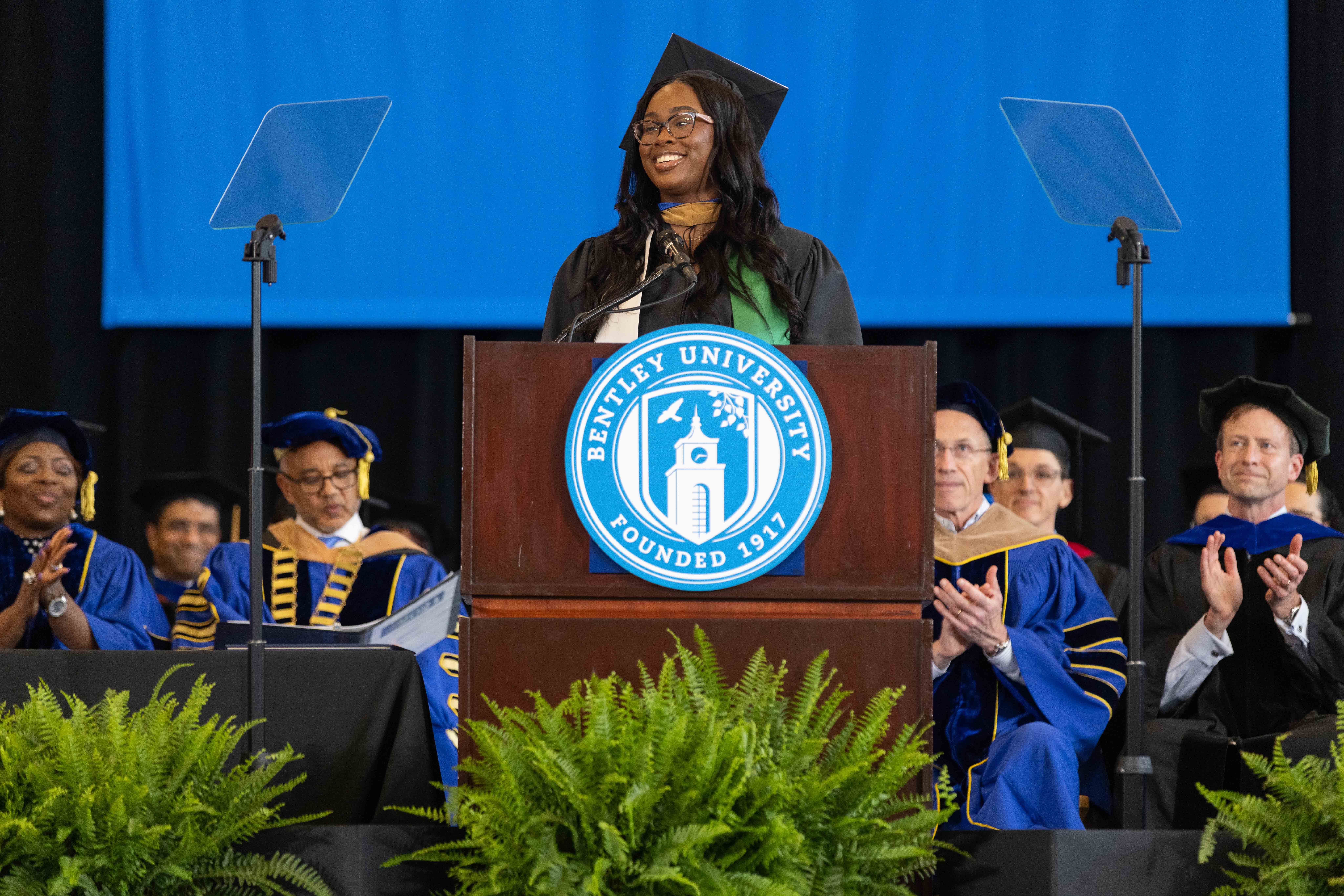 Aleshia Green '19 MSF '24 delivers her commencement address at the podium