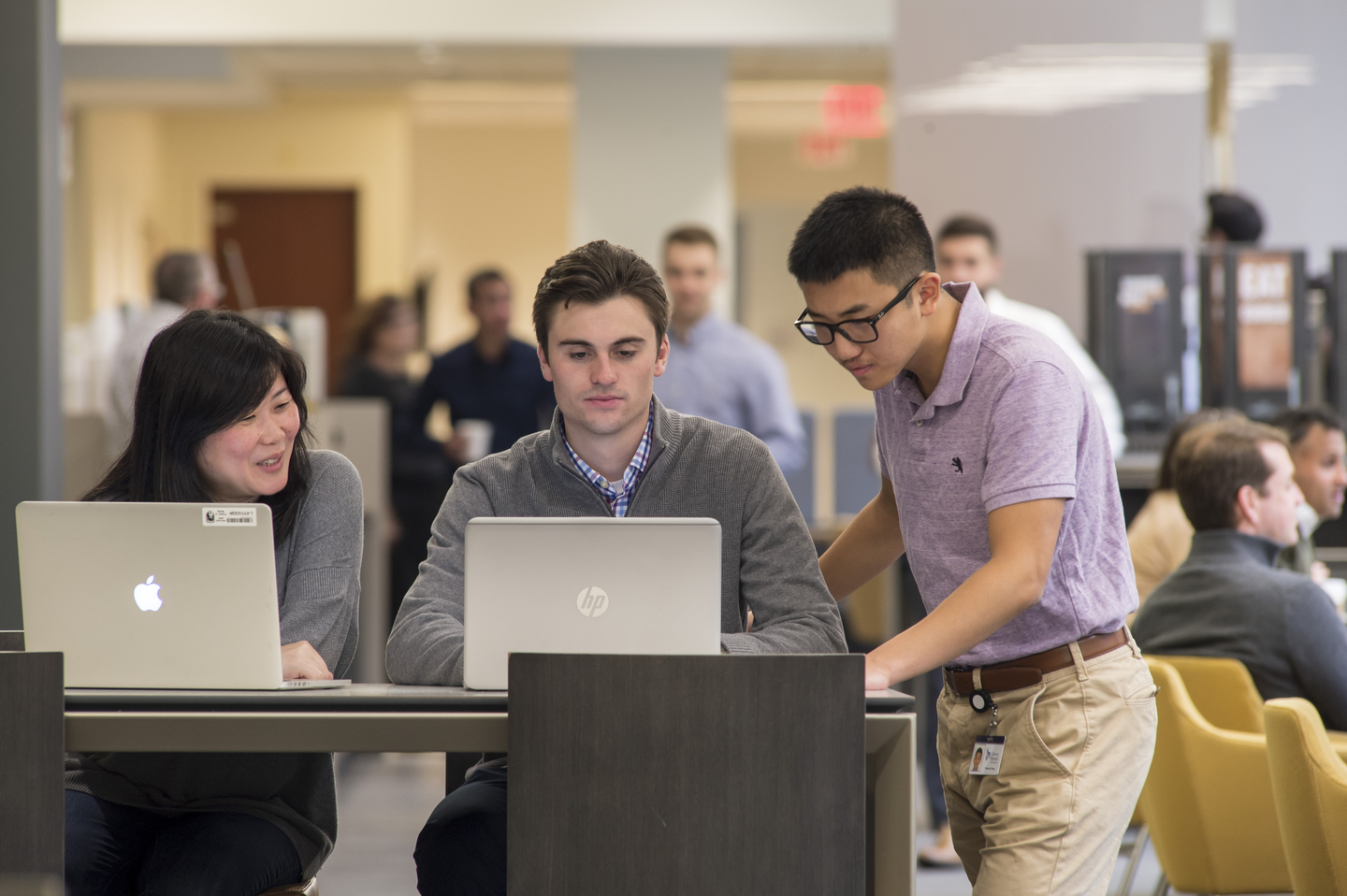 Students sitting around a laptop