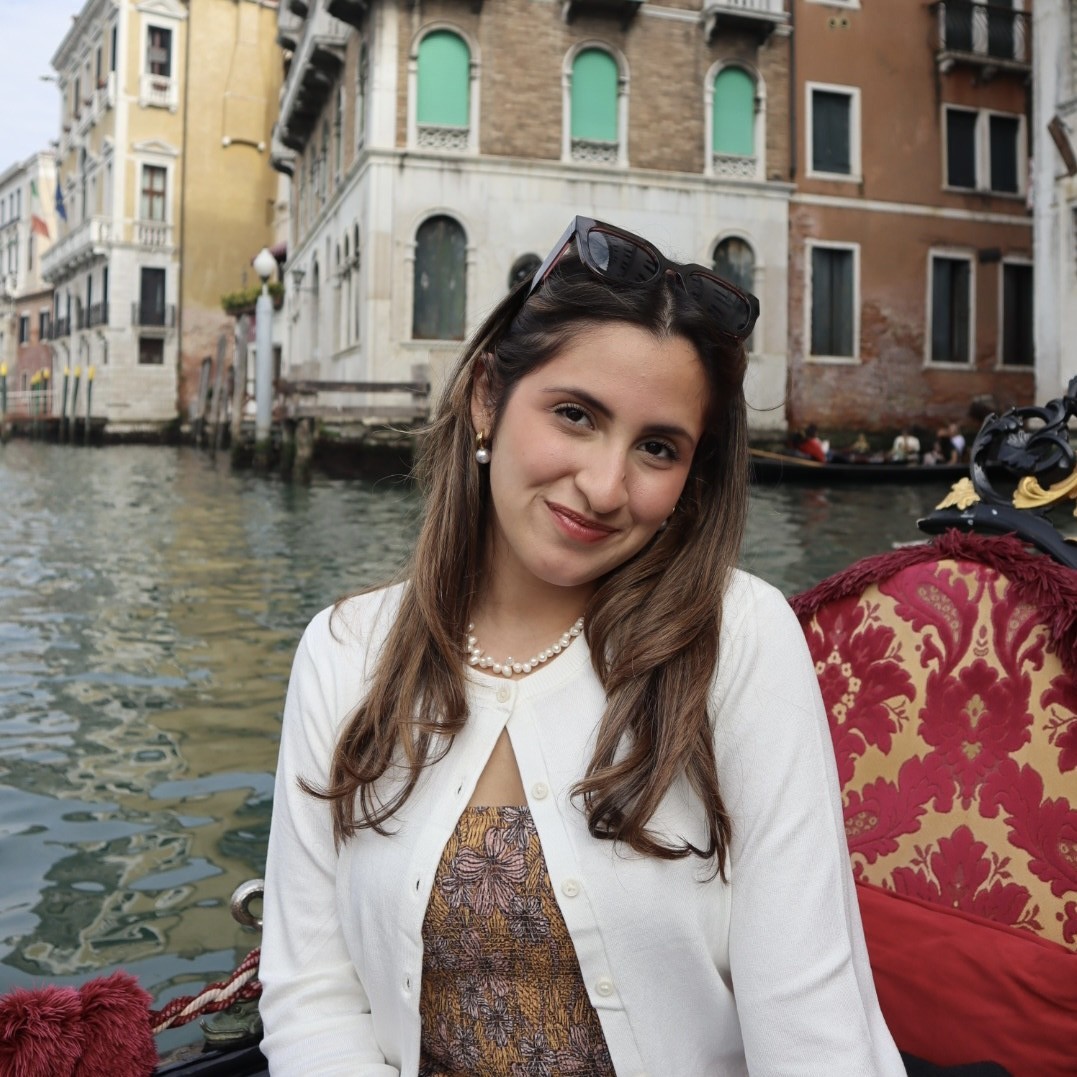 Andrea Rodriguez, a woman with brown hair and a white cardigan