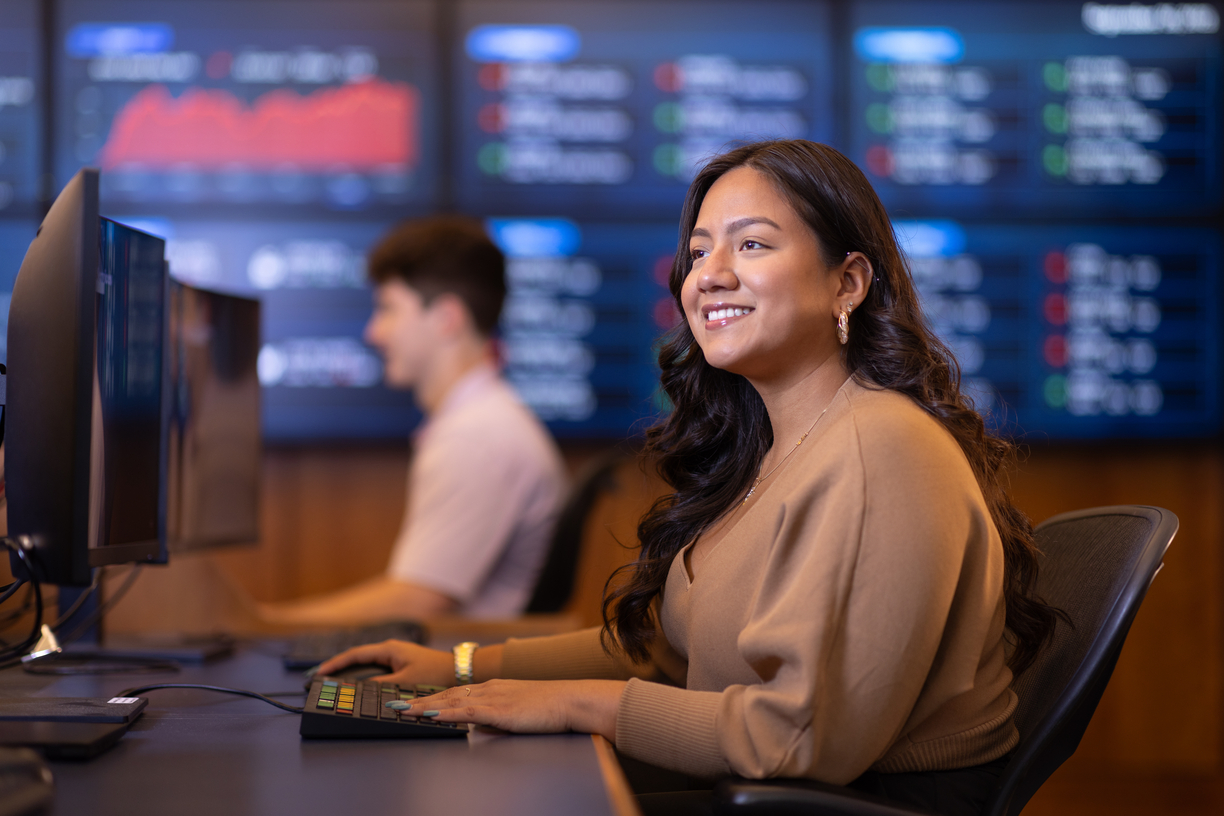 This image is a woman sitting at a terminal in Bentley's Trading Room.