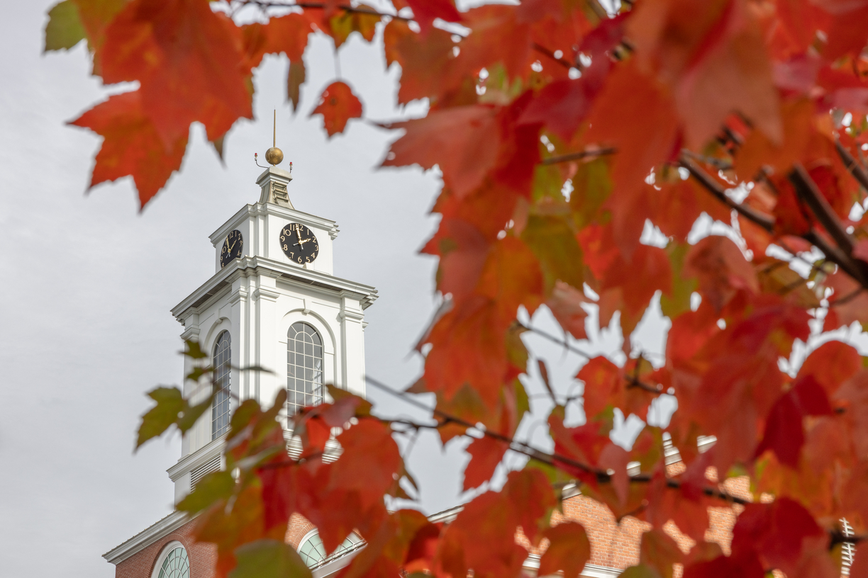 Iconic Bentley clock tower framed by autumn orange leaves