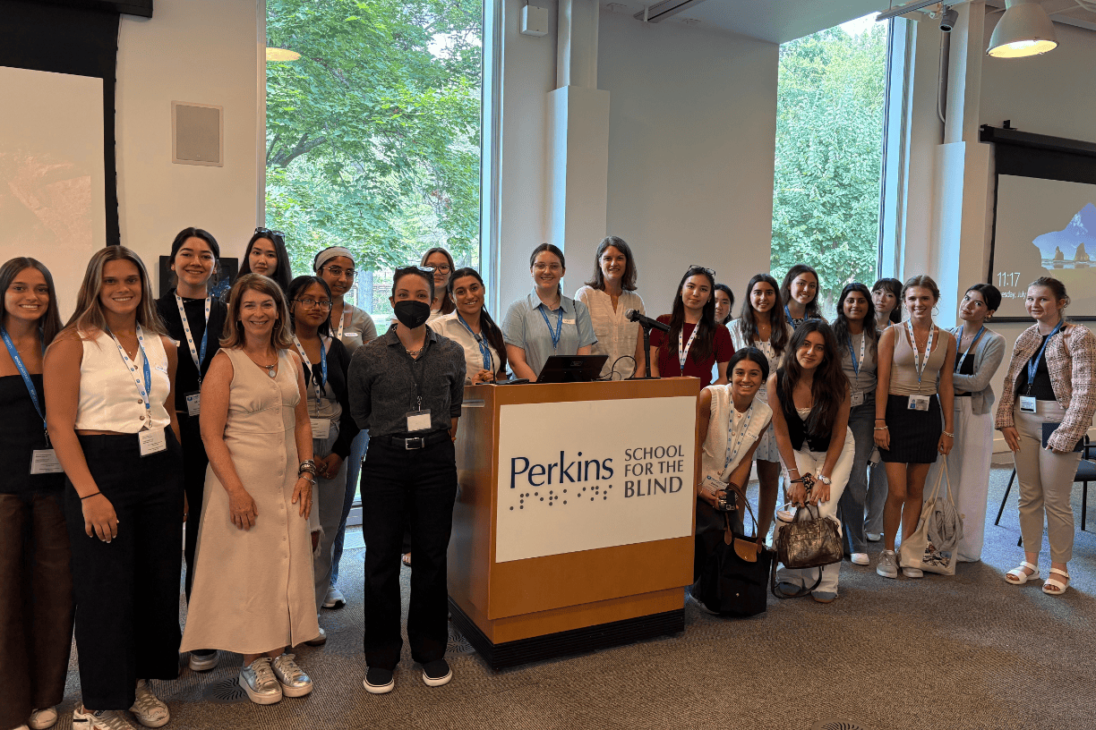 A group shot of participants in Bentley's pre-college program for aspiring women+ entrepreneurs taken during a site visit to the Perkins School for the Blind.