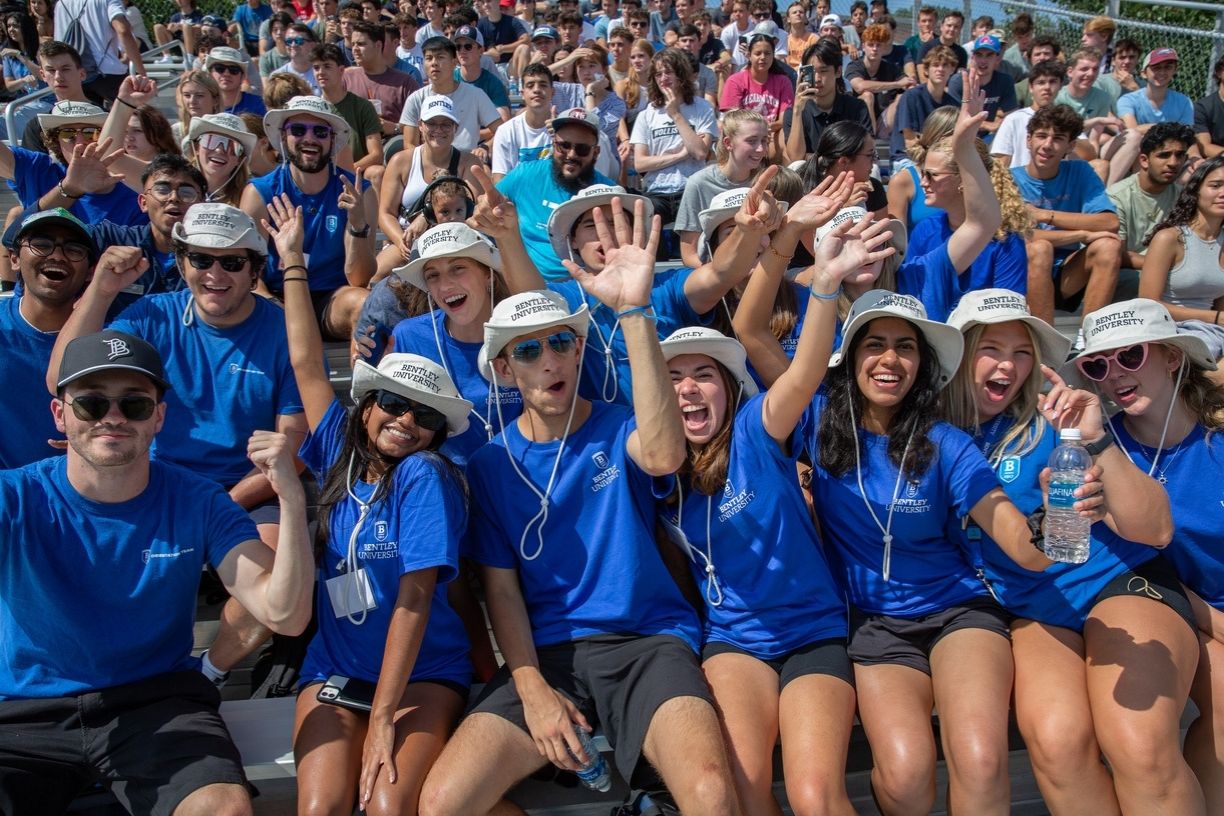 Group of Bentley Orientation Leaders and students cheering and showing school spirit