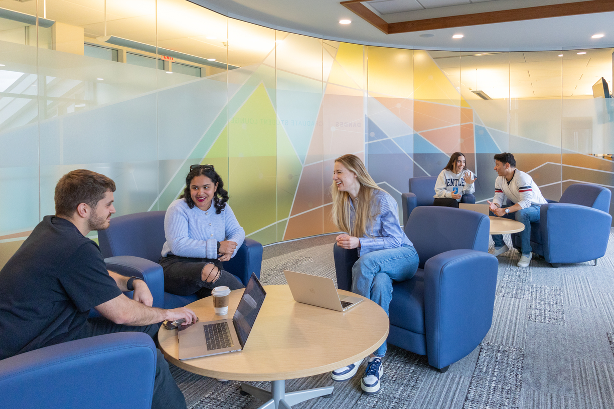 Bentley graduate students gather outside the graduate student lounge on campus