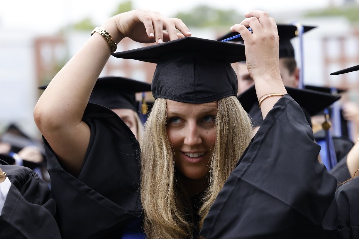 Bentley graduate turning a tassel on a graduation cap