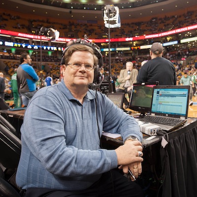 Dick Lipe sitting at an announcer booth