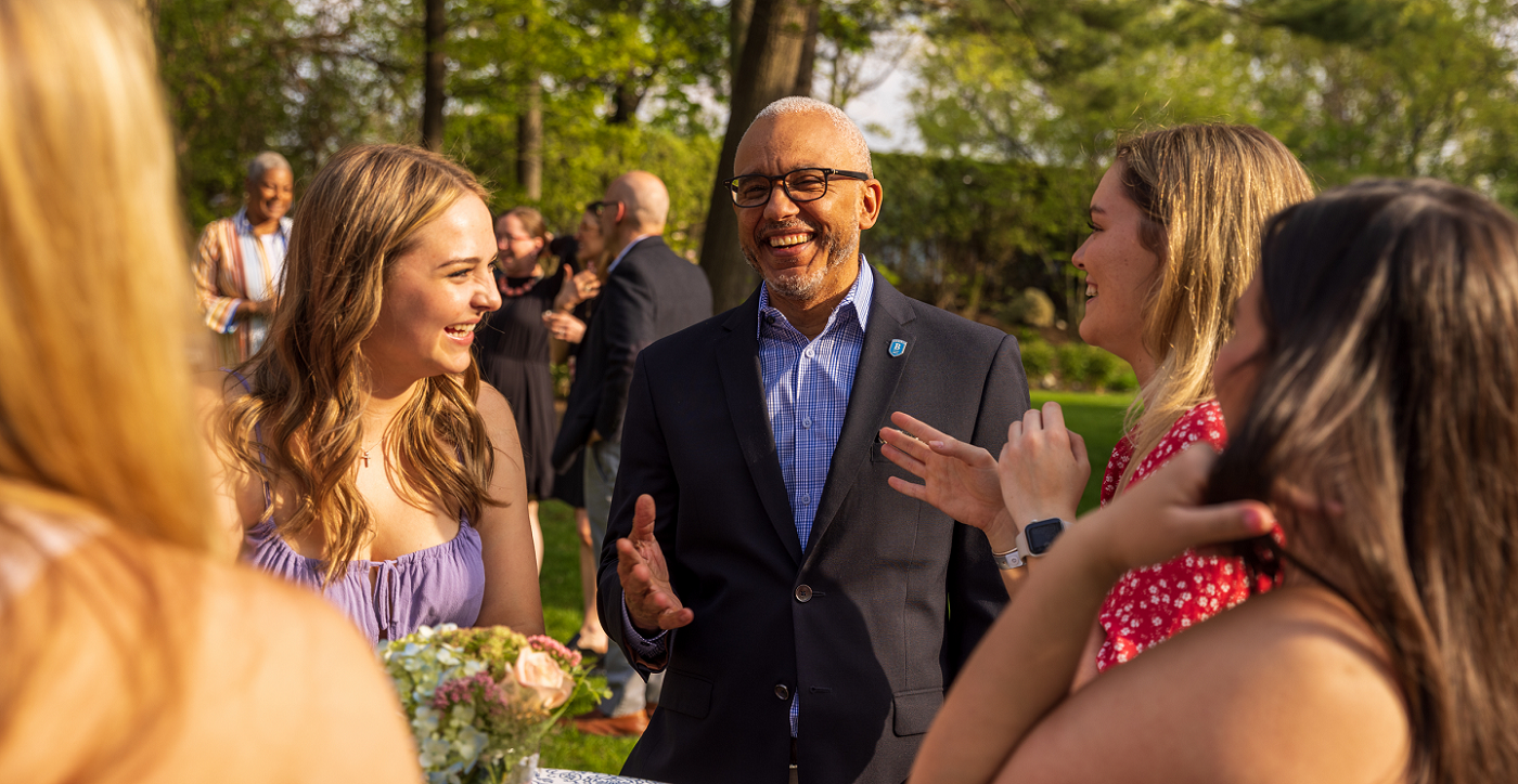 President Chrite laughing with students