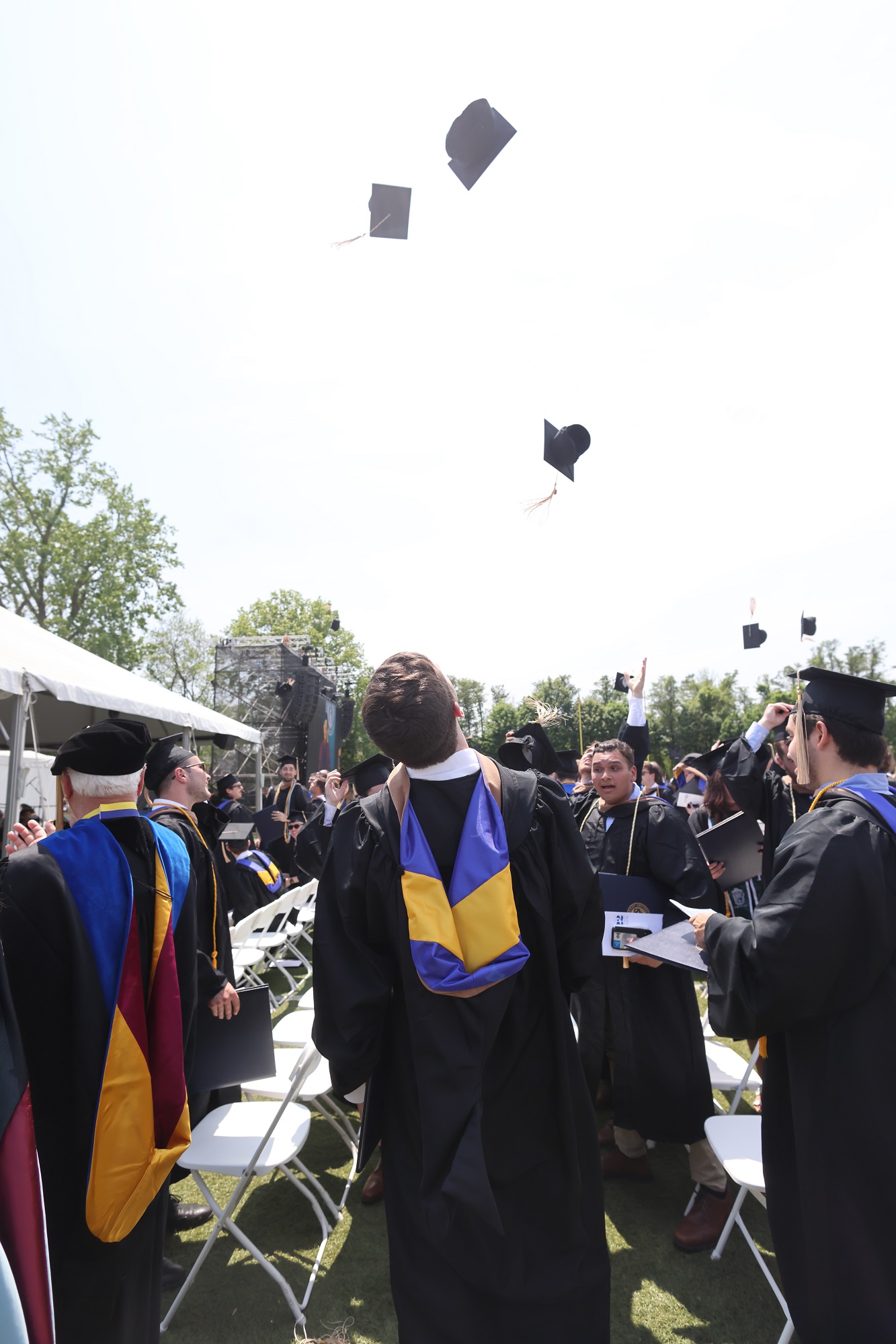 Graduates throw their caps in the air