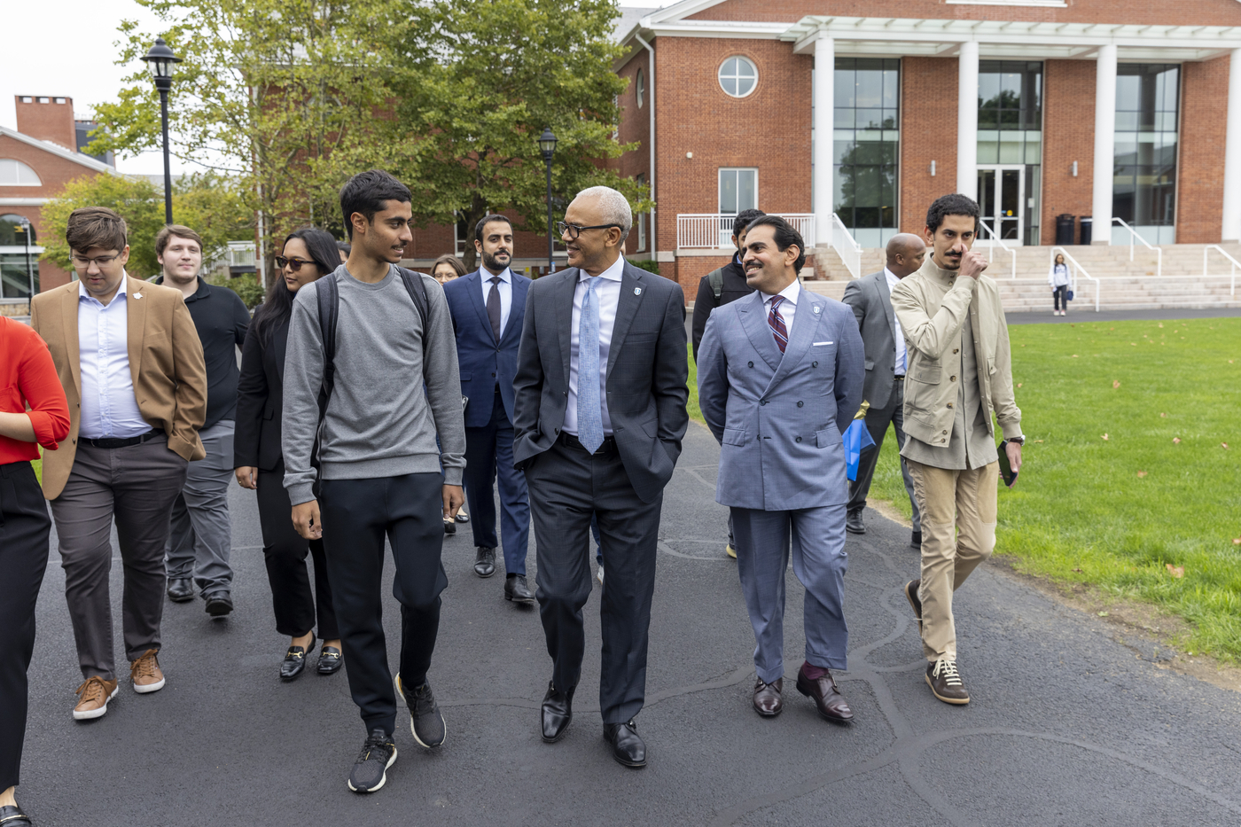 The ambassador and President Chrite walking with students on campus