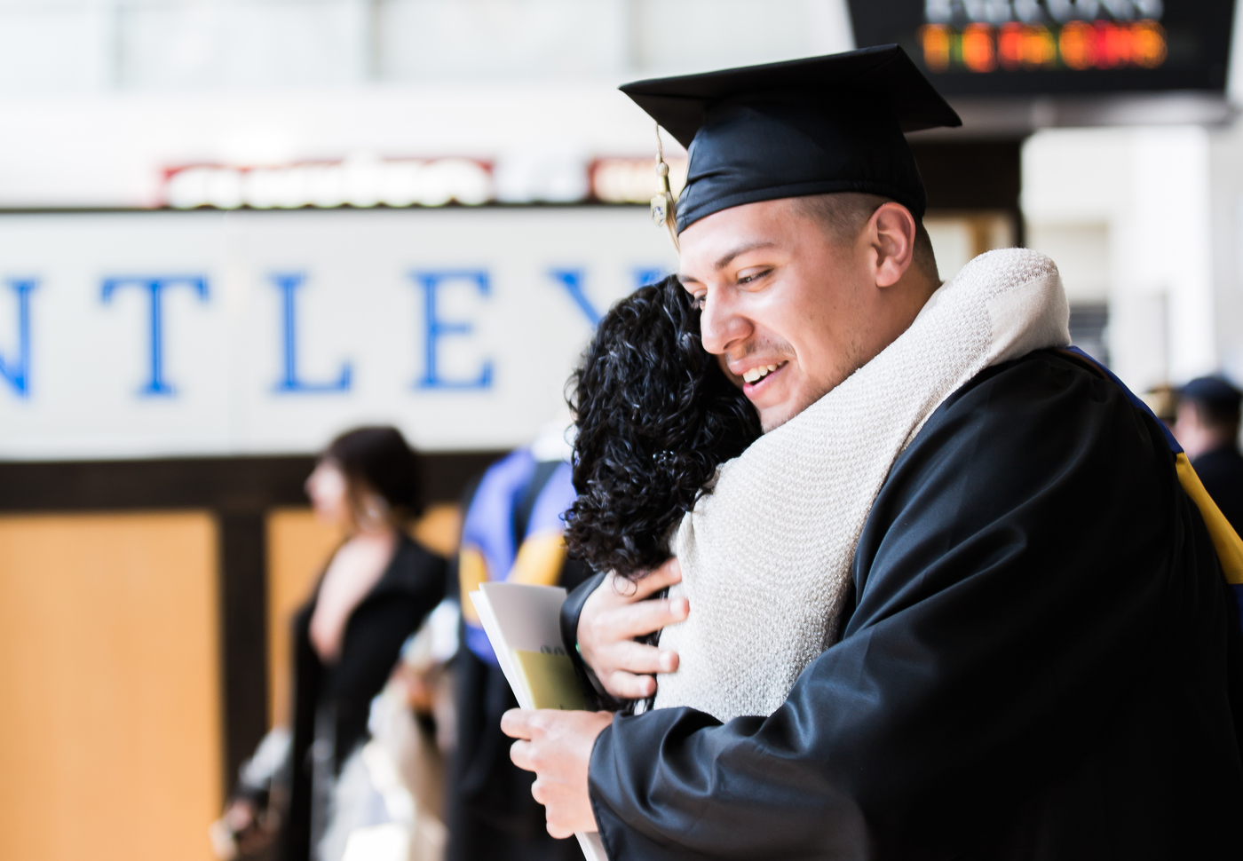 Graduate hugging someone