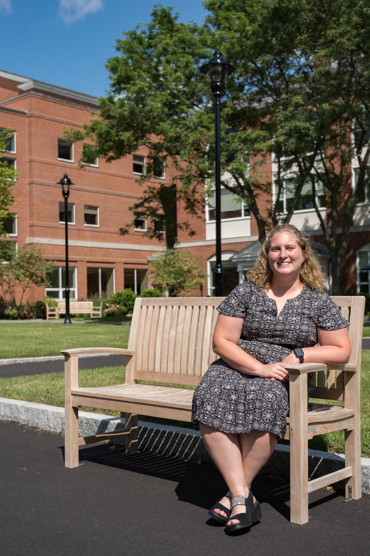 Erin Sutermeister ‘20, MSDI ‘21 sitting on bench on the Bentley campus