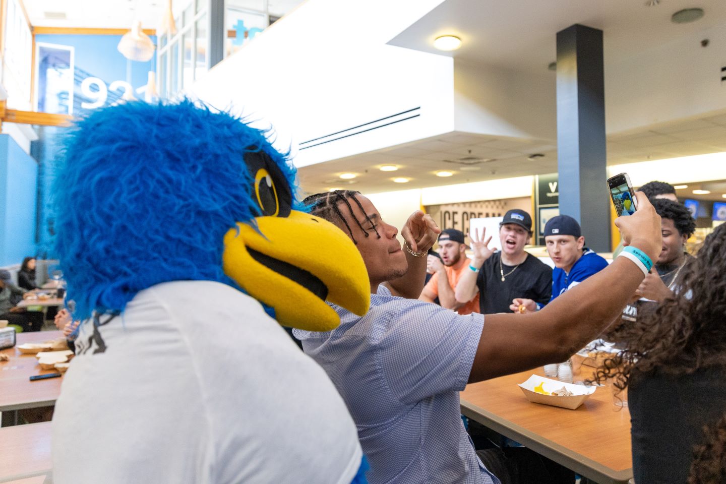 Student taking selfie with Bentley mascot