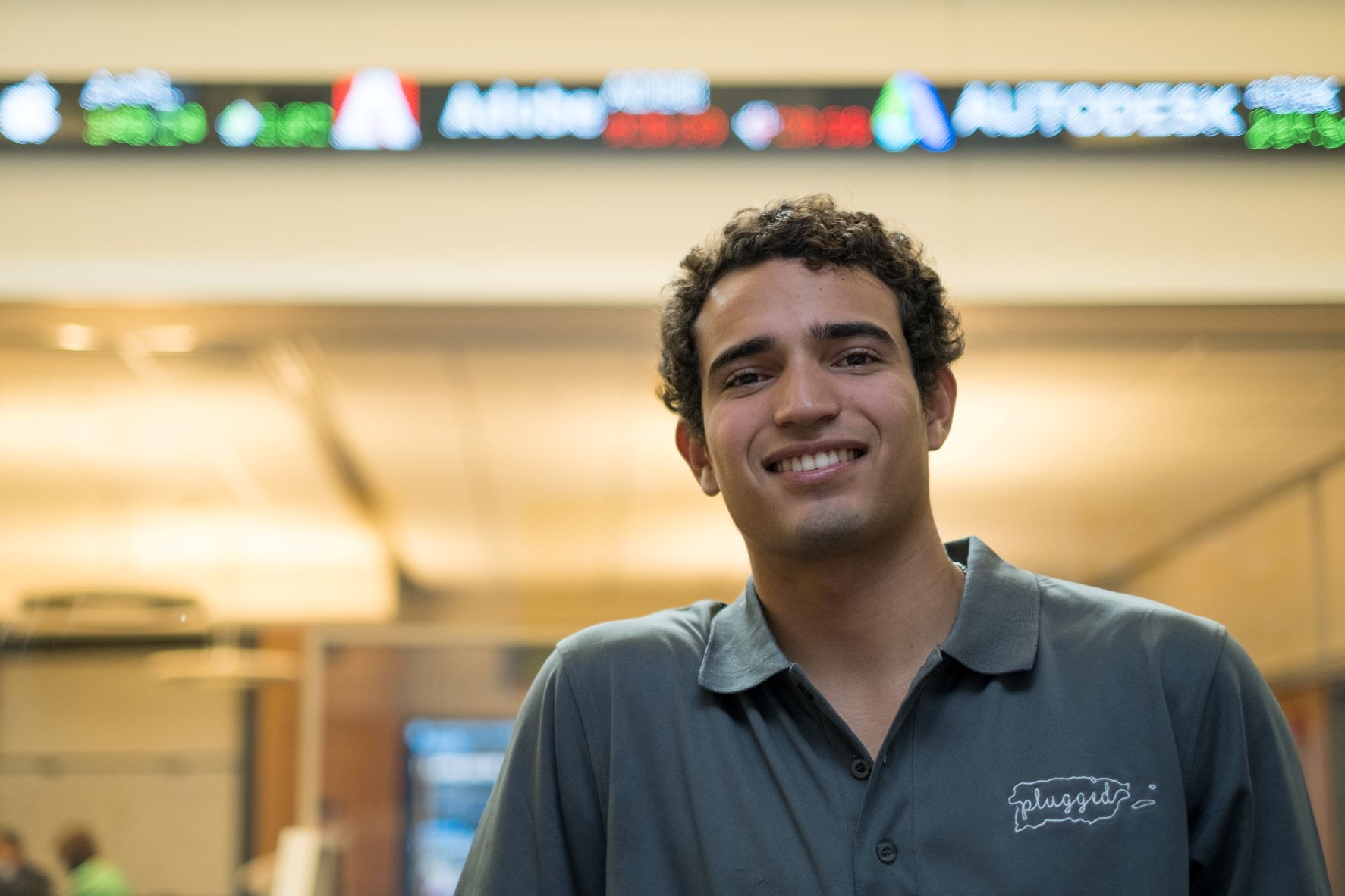 Bentley student Gabriel San Miguel in front of stock ticker