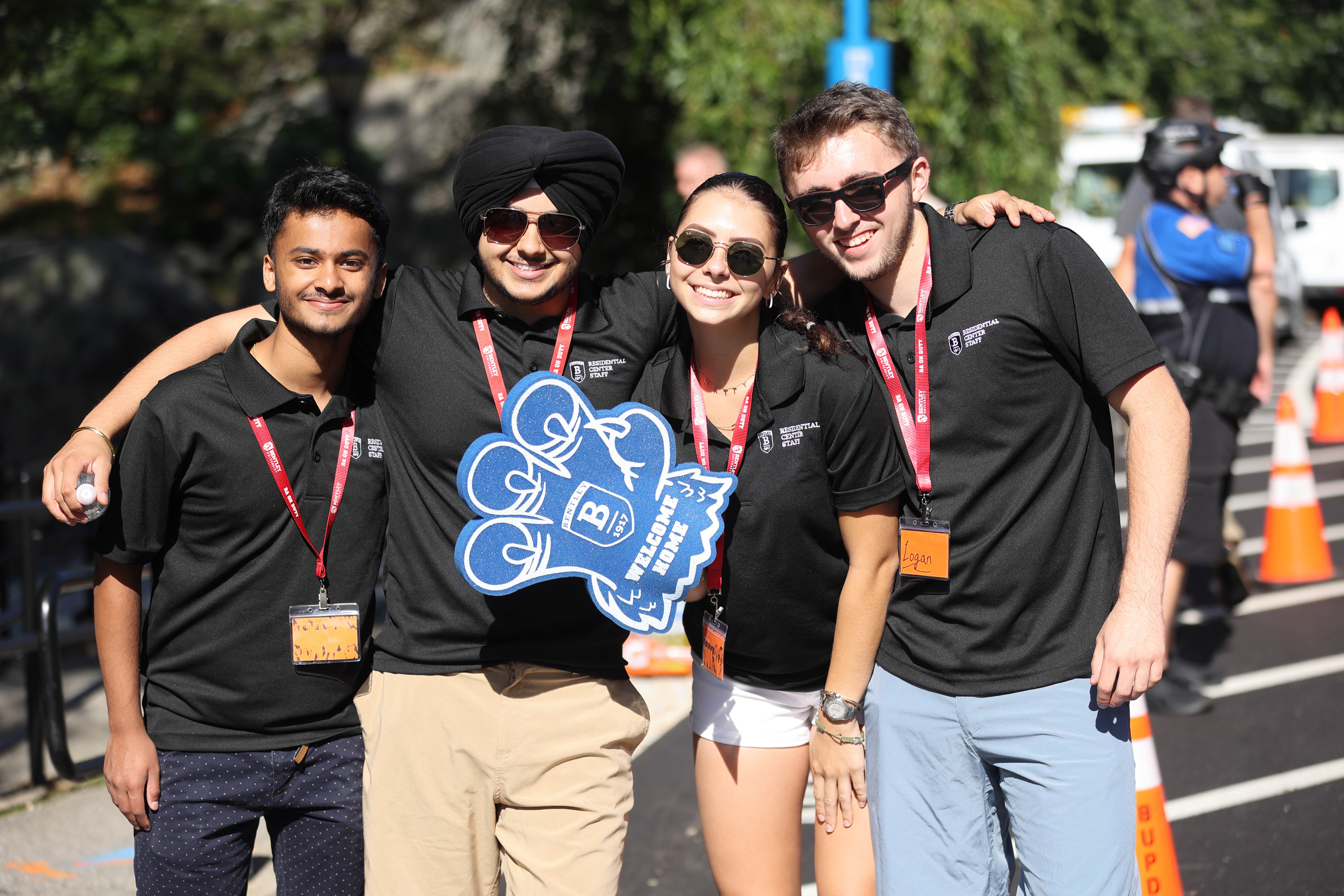 Four student orientation leaders welcome new students to campus.
