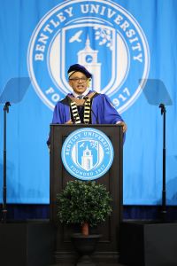 Bentley President E. LaBrent Chrite standing at podium wearing regalia