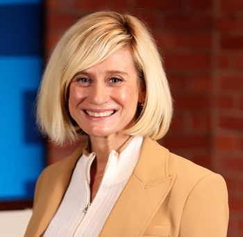 Headshot of Professor of Finance Kristi Minnick, wearing a tan blazer and cream blouse.