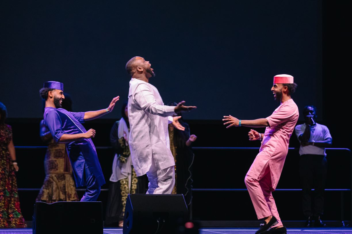 Three men in fashion show on stage