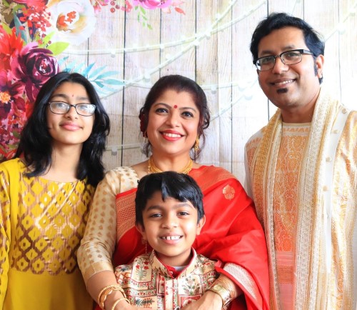 Professor Mita Das with husband, Ujjal Sakkar, 12-year-old daughter Uma and 8-year-old son Aum Anand. All are wearing traditional Indian clothing