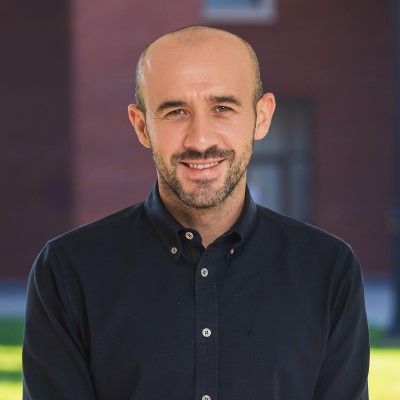 Headshot of Economics Professor Onur Altindağ, wearing a navy blue button-down shirt.