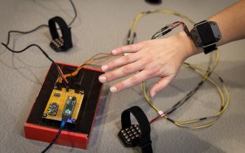 Close-up of arm wearing a prototype of the Pison wristband