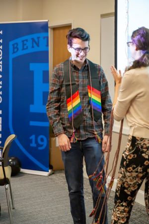 Owen Harnish receives a rainbow cord and stole