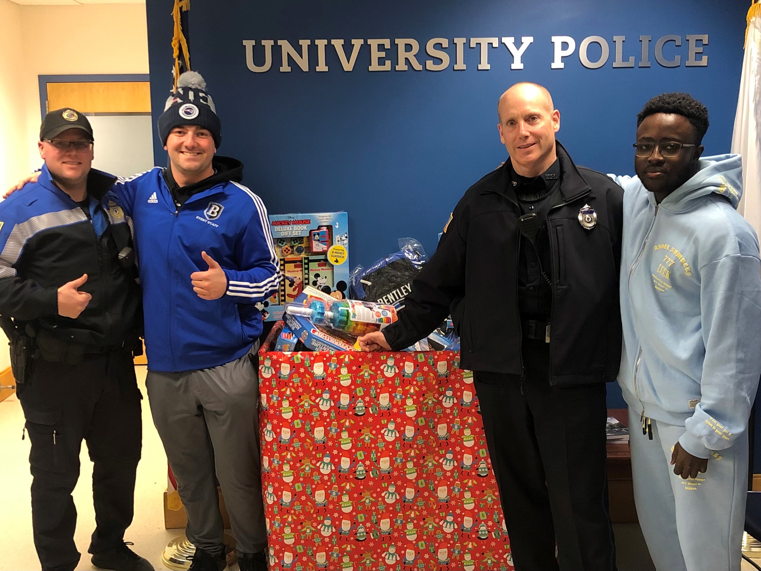 University police officers with Bentley students donating toys