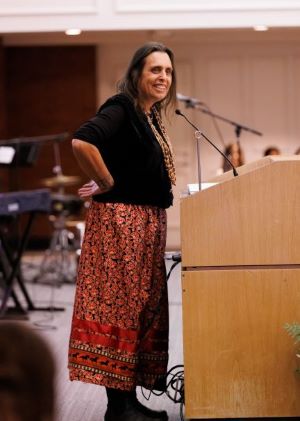 Winona LaDuke at a podium with hands on hips
