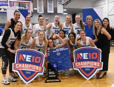 Photo of women's basketball team on court after winning the NE-10 championship