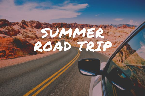 Sign for display depicting a Summer Road Trip (car on road, driving into the desert hills).